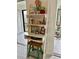 White ladder shelf with coastal decor and built-in desk at 2564 Clubhouse Cir # 204, Sarasota, FL 34232