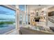 Bright living room with water views and access to the pool at 495 Mckinley Dr, Sarasota, FL 34236