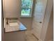 Bright bathroom featuring vanity with granite countertop, a modern faucet, and a window for natural lighting at 5018 Wagon Wheel Dr, North Port, FL 34291