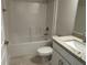 Bathroom featuring a shower/tub combo with white tile, and a vanity with a granite countertop and modern faucet at 5018 Wagon Wheel Dr, North Port, FL 34291