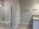 Bright bathroom featuring a glass shower, tiled floor, and a vanity with granite countertop at 5018 Wagon Wheel Dr, North Port, FL 34291