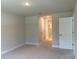 Bedroom with access to ensuite bathroom, walk-in shower and tile flooring at 5018 Wagon Wheel Dr, North Port, FL 34291