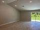 Open living room featuring tile floors, neutral walls, modern recessed lighting, and a sliding glass door at 5018 Wagon Wheel Dr, North Port, FL 34291