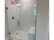 Walk-in shower with a glass door and bench, featuring white tiles at 5018 Wagon Wheel Dr, North Port, FL 34291