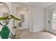 Bright foyer with tile flooring, modern decorations, and an archway entry at 7390 Divot Loop, Lakewood Ranch, FL 34202