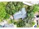 Aerial view of the property showcasing its mature trees and the layout of the home's roof at 7607 9Th Avenue Nw Dr, Bradenton, FL 34209