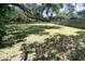 A level, grassy backyard with mature trees and wood fencing at 7607 9Th Avenue Nw Dr, Bradenton, FL 34209