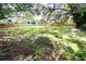 View of the expansive backyard featuring well-maintained green grass and a wooden fence along the perimeter at 7607 9Th Avenue Nw Dr, Bradenton, FL 34209