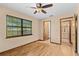 Bright bedroom with wood-look floors, ceiling fan, and an ensuite bathroom at 7607 9Th Avenue Nw Dr, Bradenton, FL 34209