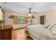 Primary bedroom with a wood floor, shuttered window, and a ceiling fan at 7607 9Th Avenue Nw Dr, Bradenton, FL 34209