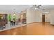 Open dining room with hardwood floors, a traditional chandelier, and an adjacent tiled space at 7607 9Th Avenue Nw Dr, Bradenton, FL 34209