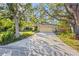 Charming single-story home featuring mature trees, a two-car garage, and a well-manicured front yard at 7607 9Th Avenue Nw Dr, Bradenton, FL 34209
