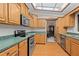 Traditional kitchen featuring wood cabinets, green countertops, stainless steel appliances, and tile backsplash at 7607 9Th Avenue Nw Dr, Bradenton, FL 34209