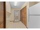 Functional laundry room with ample storage cabinets, utility sink, and a door leading to the exterior at 7607 9Th Avenue Nw Dr, Bradenton, FL 34209