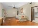 Open living room with hardwood floors, comfortable chairs, and view into laundry room with washer and dryer at 7607 9Th Avenue Nw Dr, Bradenton, FL 34209