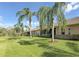 Tan single Gathering home with screened patio and tropical landscaping at 9029 Stone Harbour Loop, Bradenton, FL 34212