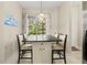 Kitchen island with granite countertop and seating for four at 9029 Stone Harbour Loop, Bradenton, FL 34212