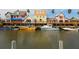 Boats docked at waterfront property with colorful buildings at 6157 Midnight Pass Rd # E12, Sarasota, FL 34242