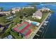 Aerial view showing community pool, tennis courts, and boat slips at 3825 Mariners Walk # 622, Cortez, FL 34215