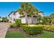 Two-story house with palm trees and well-manicured landscaping at 7390 Divot Loop, Lakewood Ranch, FL 34202