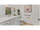 Clean bathroom with a walk-in shower and modern vanity at 7390 Divot Loop, Lakewood Ranch, FL 34202