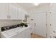 Laundry room with washer, dryer, and ample storage at 7390 Divot Loop, Lakewood Ranch, FL 34202