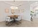 Elegant dining room with a round table and modern chairs at 7390 Divot Loop, Lakewood Ranch, FL 34202