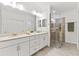 Spa-like bathroom with double vanity and walk-in shower at 7390 Divot Loop, Lakewood Ranch, FL 34202