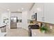 Modern kitchen with white cabinets and stainless steel appliances at 7390 Divot Loop, Lakewood Ranch, FL 34202