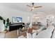 Bright living room features stylish furniture and a large TV at 7390 Divot Loop, Lakewood Ranch, FL 34202