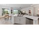 Open kitchen with island, stainless steel appliances, and golf course view at 7390 Divot Loop, Lakewood Ranch, FL 34202