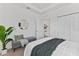 Guest bedroom with a comfortable sitting area and mirrored accent wall at 7390 Divot Loop, Lakewood Ranch, FL 34202