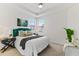 Bright bedroom with a green velvet headboard and plenty of natural light at 7390 Divot Loop, Lakewood Ranch, FL 34202