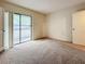 Bright bedroom with carpet flooring and access to a private balcony at 2587 Countryside Blvd # 6111, Clearwater, FL 33761