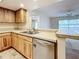 Kitchen with light wood cabinets, tile counters, and breakfast bar at 2587 Countryside Blvd # 6111, Clearwater, FL 33761