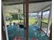 Relaxing screened porch with outdoor seating and backyard view at 427 Blackburn St, Englewood, FL 34223