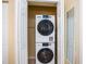 Stackable washer and dryer in a well-lit laundry closet at 6157 Midnight Pass Rd # A51, Sarasota, FL 34242