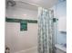Bathroom with shower/tub combo and beachy decor at 6157 Midnight Pass Rd # A51, Sarasota, FL 34242