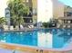 Refreshing community pool with surrounding lounge chairs at 6157 Midnight Pass Rd # A51, Sarasota, FL 34242