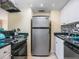Bright kitchen with stainless steel refrigerator and stove at 6157 Midnight Pass Rd # A51, Sarasota, FL 34242