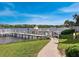 Community dock with walkway leading to the water at 6157 Midnight Pass Rd # A51, Sarasota, FL 34242