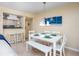 White dining table and bench set with teal accents at 6157 Midnight Pass Rd # A51, Sarasota, FL 34242