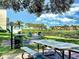 Community picnic area with grills and tables under shade trees at 6157 Midnight Pass Rd # A51, Sarasota, FL 34242