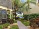 Brick-paved walkway through a lush, tropical backyard with water views at 6157 Midnight Pass Rd # A51, Sarasota, FL 34242