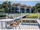 Relaxing waterfront dock with seating and tables at 6157 Midnight Pass Rd # A51, Sarasota, FL 34242
