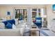 Open concept living space with light-colored sofa and blue accent chairs at 6157 Midnight Pass Rd # A51, Sarasota, FL 34242