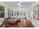 Bright sunroom with hardwood floors, white walls, and futon at 1332 3Rd W Ave, Bradenton, FL 34205