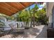 Peaceful patio with lounge chairs, dining area, and lush landscaping at 1332 3Rd W Ave, Bradenton, FL 34205