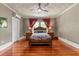 Charming bedroom with hardwood floors, decorative ceiling, and ample natural light at 1332 3Rd W Ave, Bradenton, FL 34205