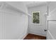 Bright walk-in closet with wood floors and white beadboard walls at 1332 3Rd W Ave, Bradenton, FL 34205